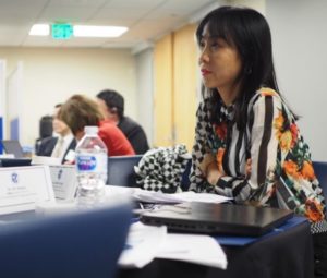 A delegate listens as Susan Dentzer presents on "Health and Healthcare in the United States."